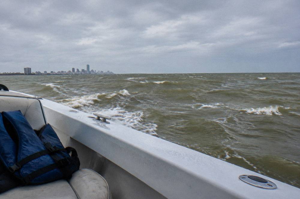 Whitecaps on an open bay with a gray sky and an empty horizon